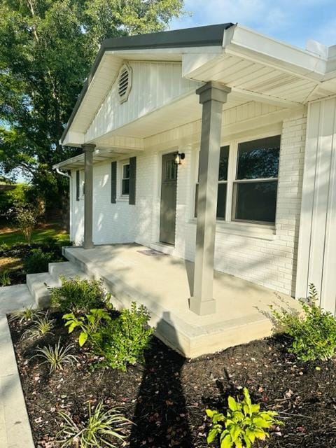 view of exterior entry featuring a porch