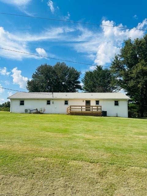 back of property featuring a lawn