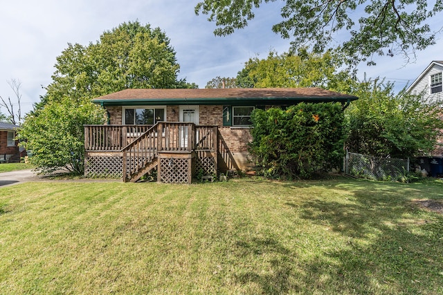 ranch-style house with a wooden deck and a front lawn