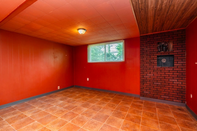 unfurnished room featuring wood walls