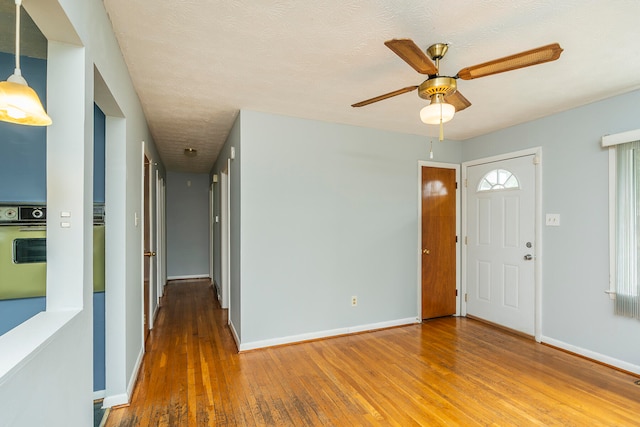 entryway featuring a textured ceiling, ceiling fan, and hardwood / wood-style flooring