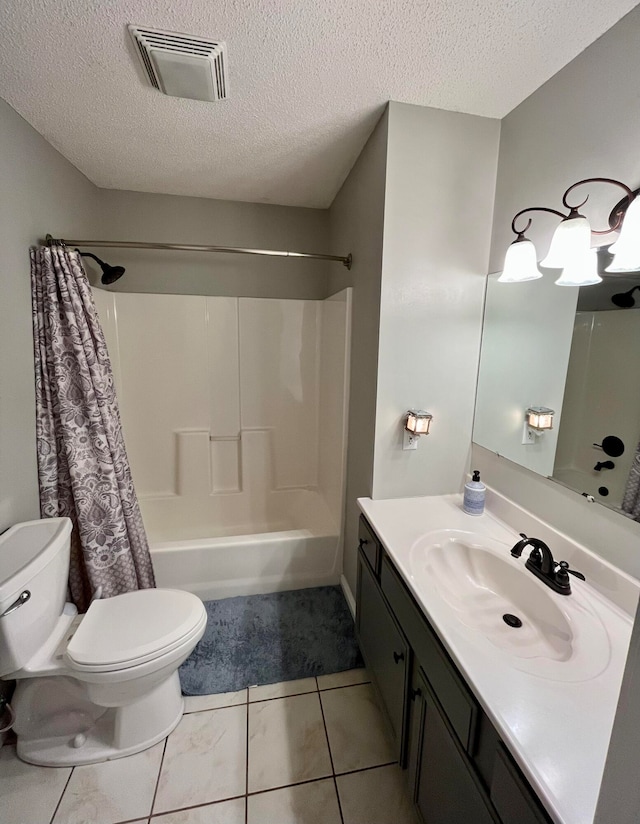 full bathroom with tile patterned floors, toilet, shower / bath combination with curtain, vanity, and a textured ceiling