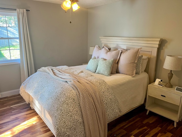 bedroom featuring dark hardwood / wood-style floors and ceiling fan