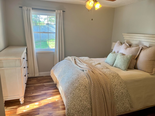 bedroom featuring ceiling fan, a textured ceiling, and hardwood / wood-style floors