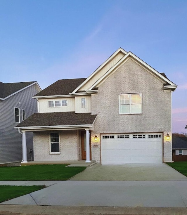 view of front of home with a yard and a garage