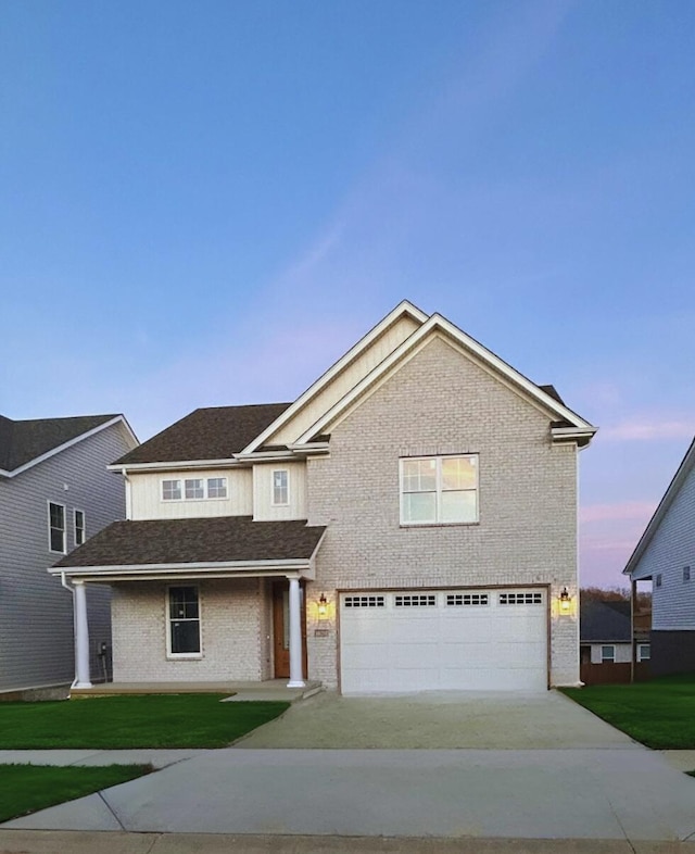 view of front of house with a yard and a garage