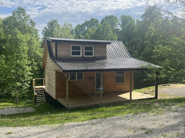 view of front of house with metal roof and stairs