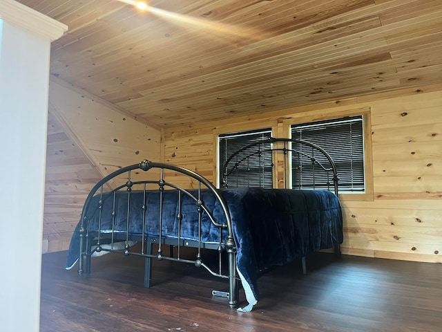 bedroom with wood walls, wooden ceiling, and dark hardwood / wood-style flooring