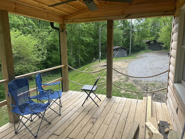 wooden terrace featuring a view of trees