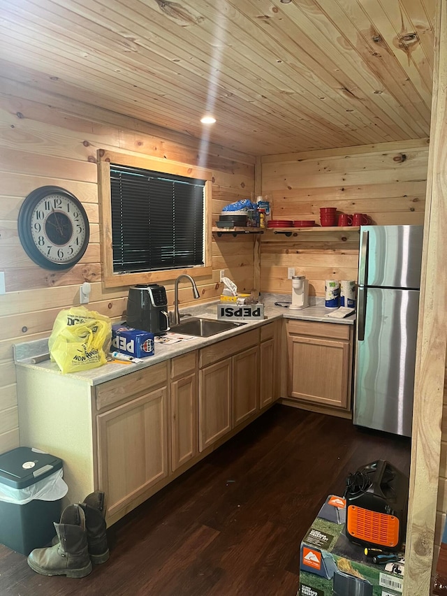 kitchen featuring dark wood-type flooring, wood ceiling, stainless steel refrigerator, and sink