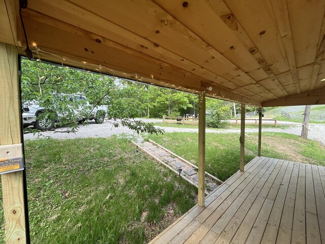 wooden terrace with a lawn