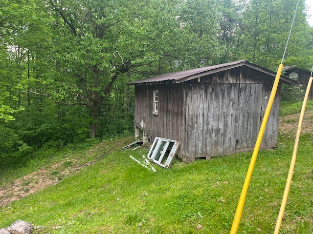 view of outbuilding featuring a yard