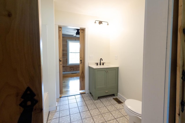 bathroom featuring tile patterned floors, ceiling fan, vanity, and toilet