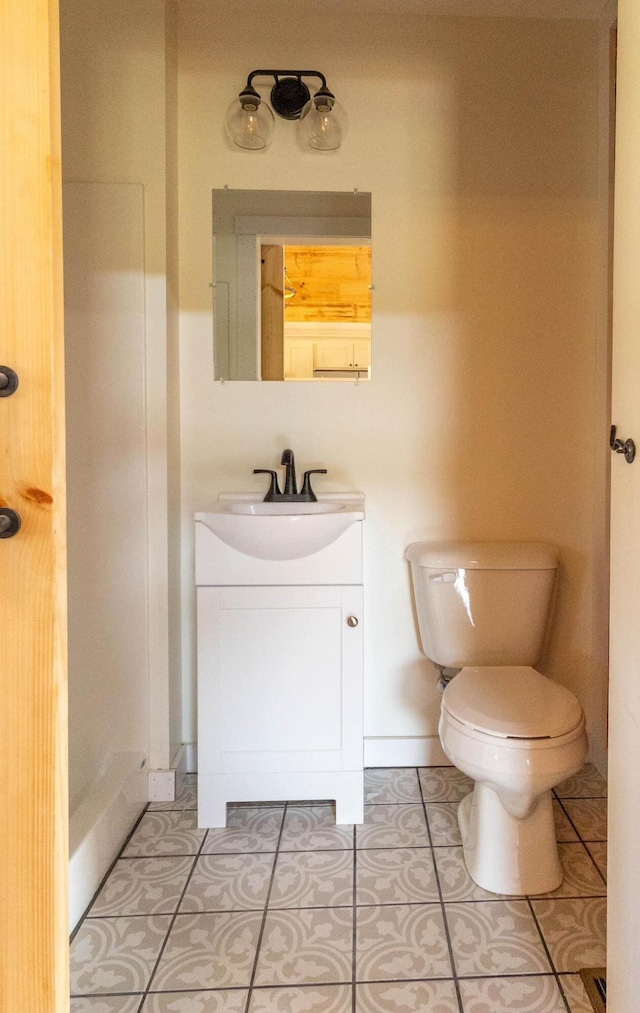 bathroom with tile patterned floors, vanity, and toilet