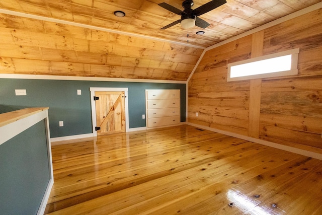 additional living space featuring hardwood / wood-style floors, wood walls, lofted ceiling, and wood ceiling