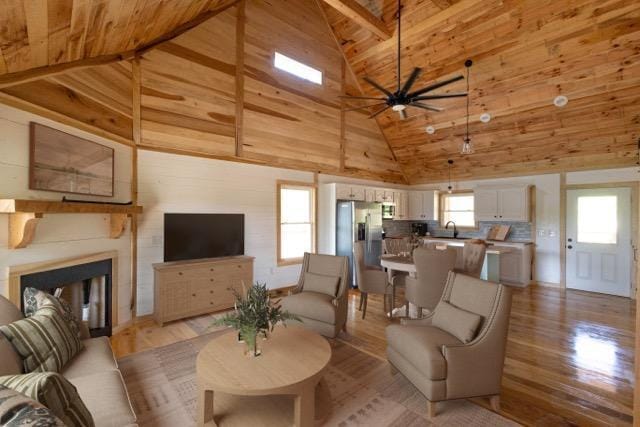 living room with wooden ceiling, plenty of natural light, and light hardwood / wood-style floors