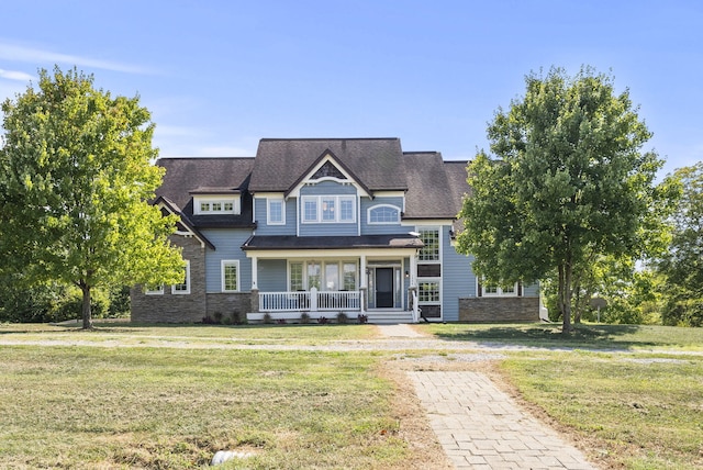 view of front of home with a front yard and a porch