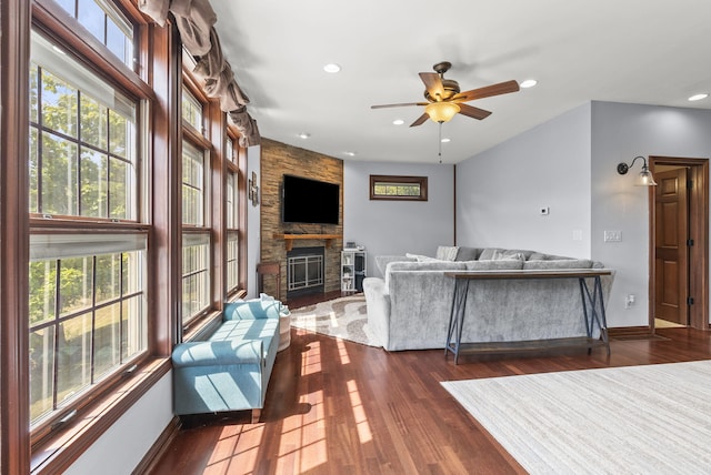 living room featuring ceiling fan, a fireplace, and dark hardwood / wood-style flooring