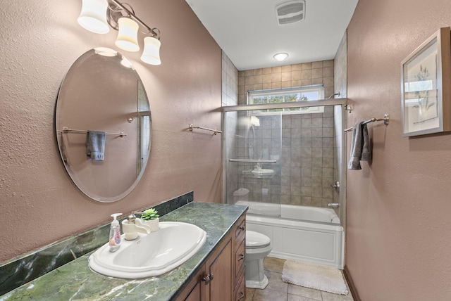 full bathroom with vanity, toilet, tile patterned floors, and enclosed tub / shower combo