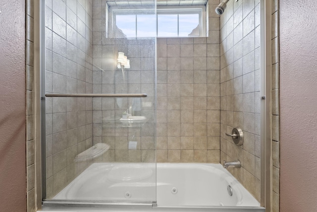 bathroom featuring shower / bath combination with glass door