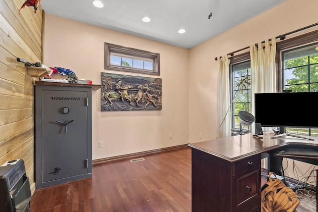 office space featuring dark hardwood / wood-style floors and heating unit