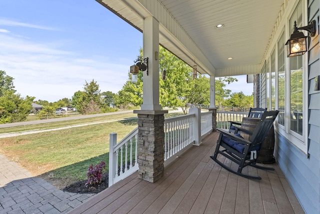 wooden deck with a yard and a porch