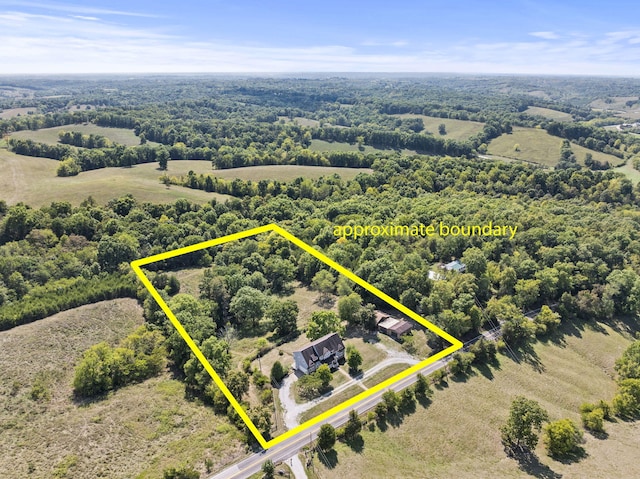 birds eye view of property with a rural view