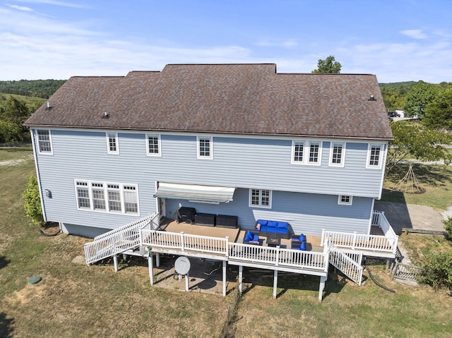 back of property featuring an outdoor living space, a yard, and a deck