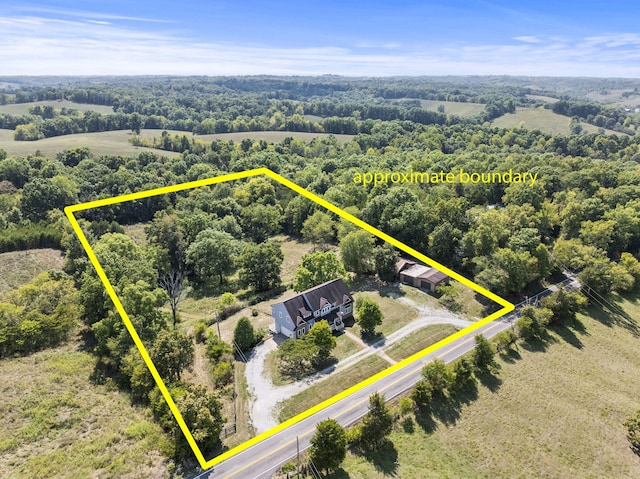 birds eye view of property with a rural view