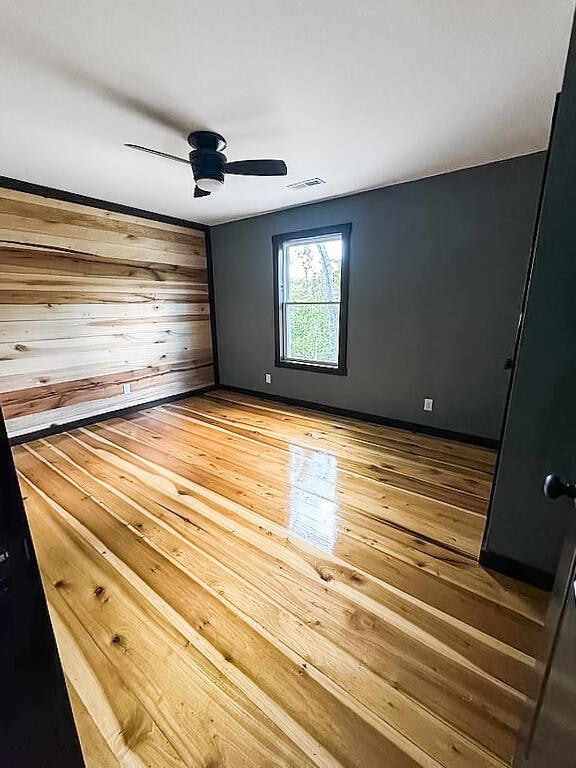 unfurnished bedroom with hardwood / wood-style flooring and ceiling fan