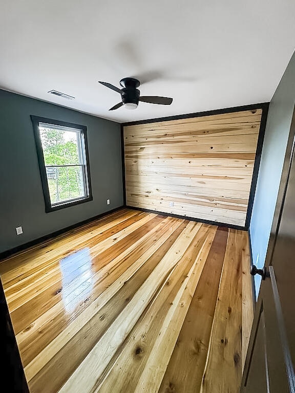 unfurnished bedroom with ceiling fan and light hardwood / wood-style floors