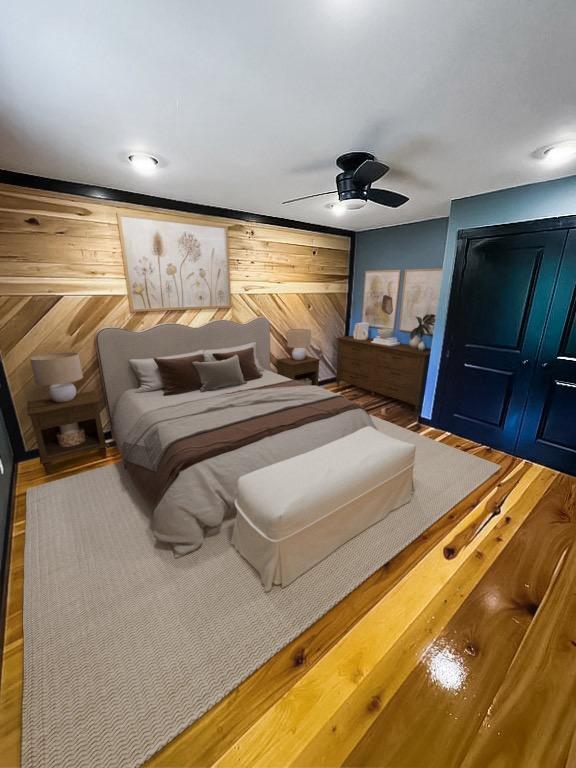 bedroom with ceiling fan and wooden walls