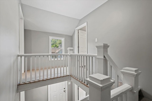 stairway featuring vaulted ceiling