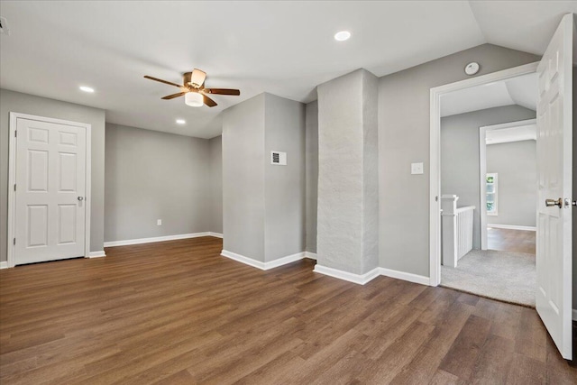 unfurnished room featuring lofted ceiling, ceiling fan, and dark hardwood / wood-style floors