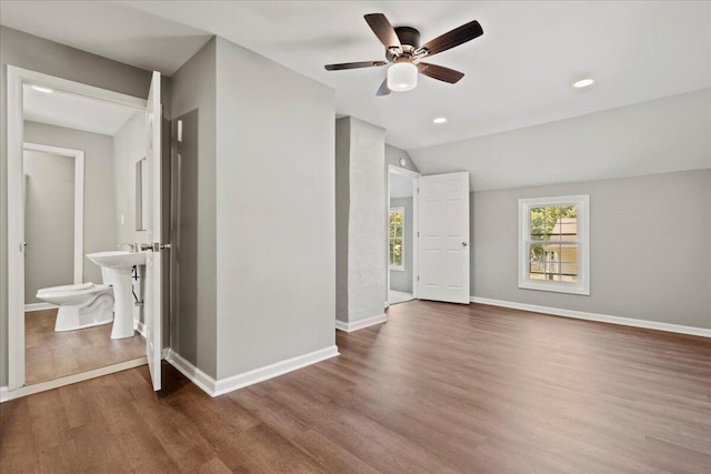 spare room featuring lofted ceiling, ceiling fan, and dark hardwood / wood-style flooring