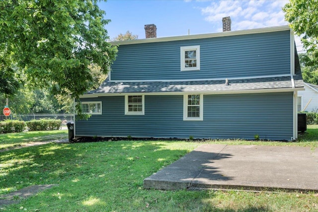 rear view of house with a lawn