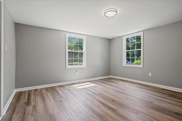 unfurnished room with wood-type flooring