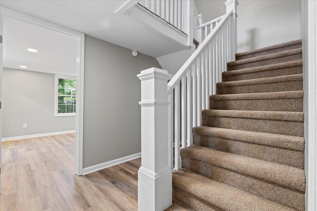 staircase featuring wood-type flooring