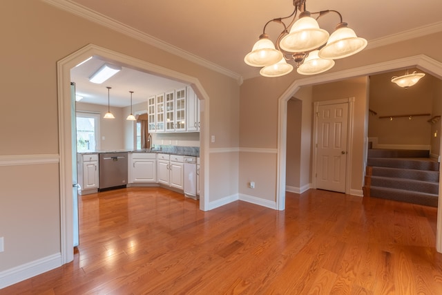 kitchen with dishwasher, light hardwood / wood-style flooring, a notable chandelier, and white cabinetry