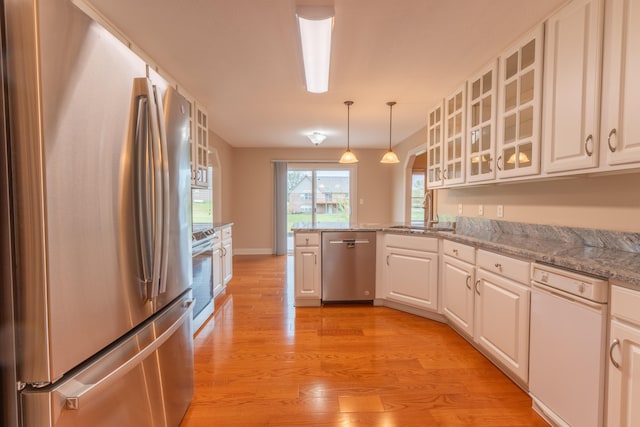 kitchen with white cabinetry, light hardwood / wood-style floors, appliances with stainless steel finishes, and sink