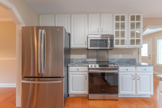 kitchen with appliances with stainless steel finishes and white cabinetry