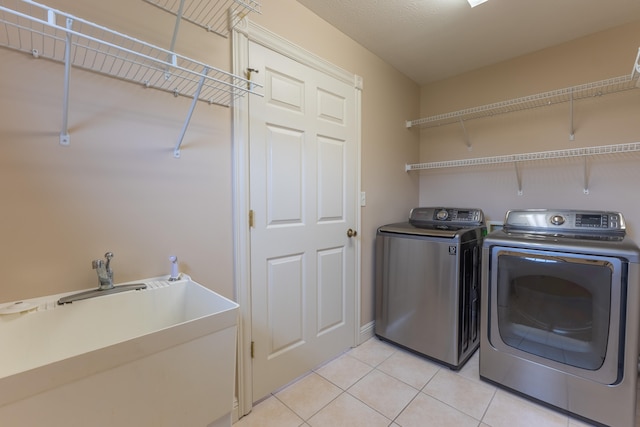 washroom featuring light tile patterned flooring and separate washer and dryer