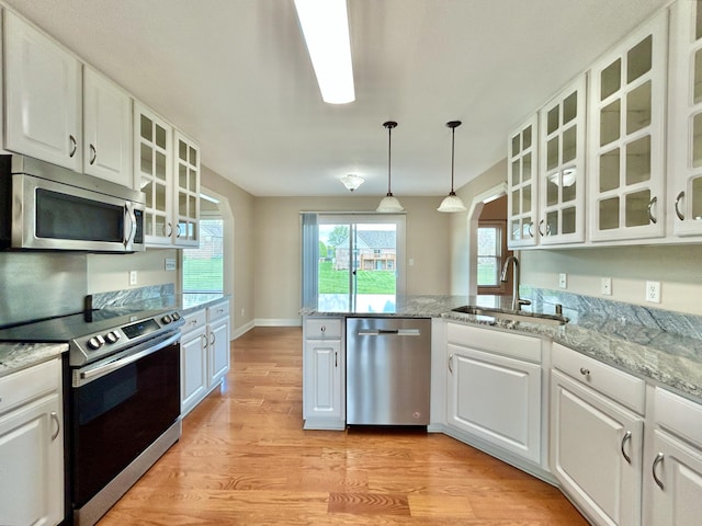 244 Water Cliff Dr, Somerset, KY 42503 - spare room featuring arched walkways, ceiling fan, baseboards, and wood finished floors