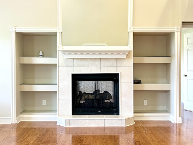 244 Water Cliff Dr, Somerset, KY 42503 - unfurnished living room with a tray ceiling, light wood-type flooring, a ceiling fan, a tile fireplace, and baseboards