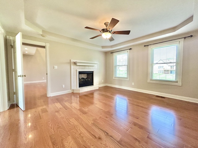 244 Water Cliff Dr, Somerset, KY 42503 - unfurnished living room with a tray ceiling, ceiling fan, light wood-style floors, and visible vents