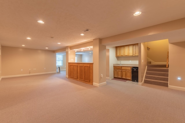 basement with indoor wet bar and light colored carpet