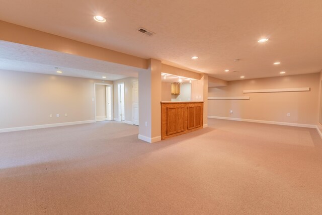 basement featuring light carpet