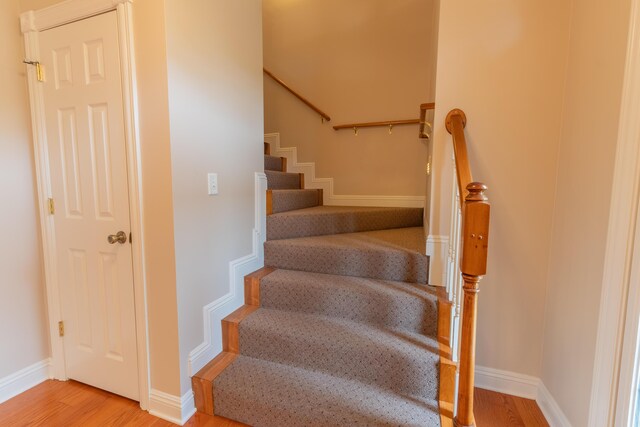 stairs featuring hardwood / wood-style flooring