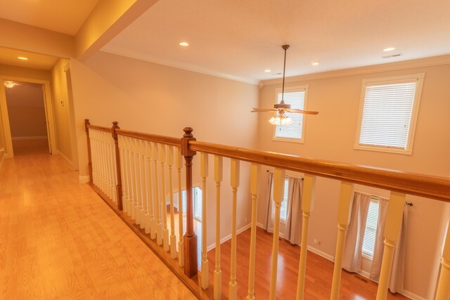 corridor featuring crown molding and light hardwood / wood-style floors