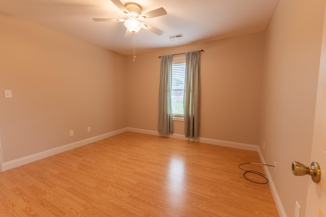 empty room featuring ceiling fan and light wood-type flooring